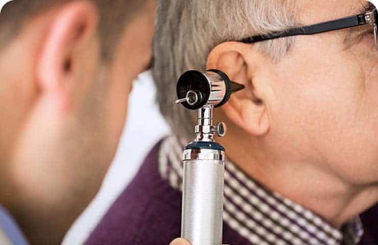 Doctor Examining old Patients Ear